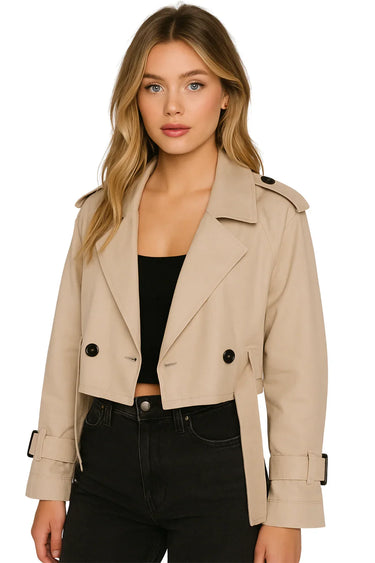 Woman wearing a crop trench jacket on a white background
